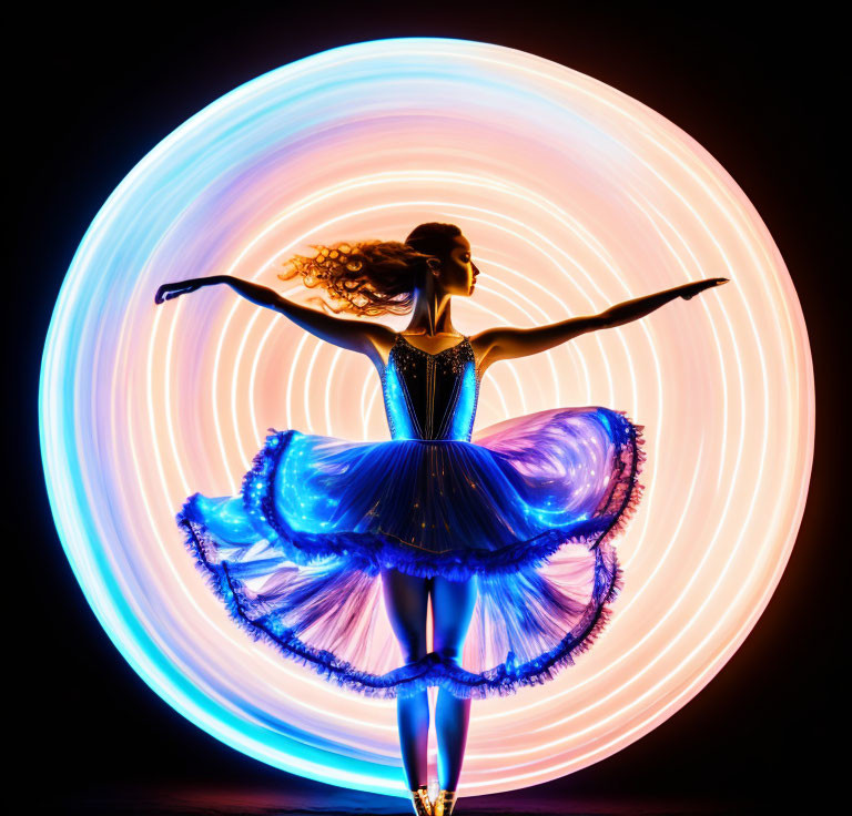 Silhouette of dancer with outstretched arms against vibrant swirling light pattern