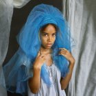 Vibrant blue-haired girl in swirling white smoke, wearing ruffled dress