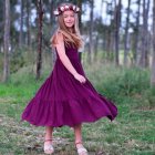 Illustration of girl in purple dress with floral crown in colorful meadow