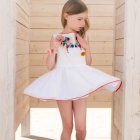 Young girl in white dress with pastel rainbow colors in ethereal setting