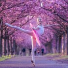 Graceful ballerina in pink tutu amidst whimsical, colorful forest setting.