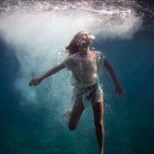 Woman with jellyfish-like features in serene underwater scene