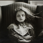 Young girl with blue hair in a plush armchair