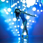 Blue Alien Creature Perched on Rock with Glowing Orbs in Blue Background