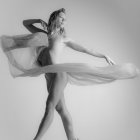 Graceful Woman in Sheer White Garment Mid-Dance