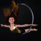 Vivid Orange and Blue Hair Woman Floating in Luminescent Circle