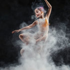 Dancer in flowing garment amidst swirling smoke