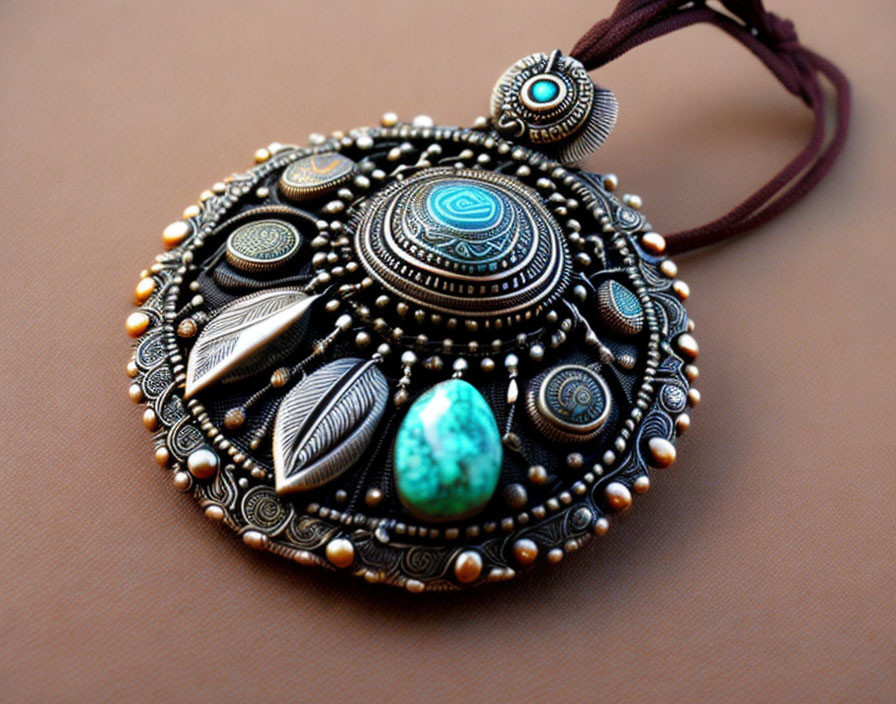 Circular Black Pendant with Turquoise Accents and Silver Leaf Patterns