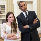 Man and woman posing with crossed arms in suit and lace dress