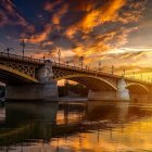 Fiery sky sunset over arched bridge and water