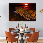 Contemporary dining room with large painting, orange chairs, round table, pendant lights, and green plant