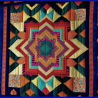 Symmetrical patterned quilt with vibrant colors and floral motifs