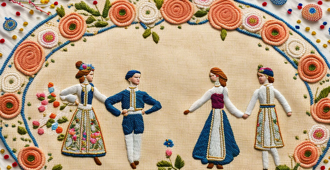 Folk dancers in traditional outfits embroidered on fabric