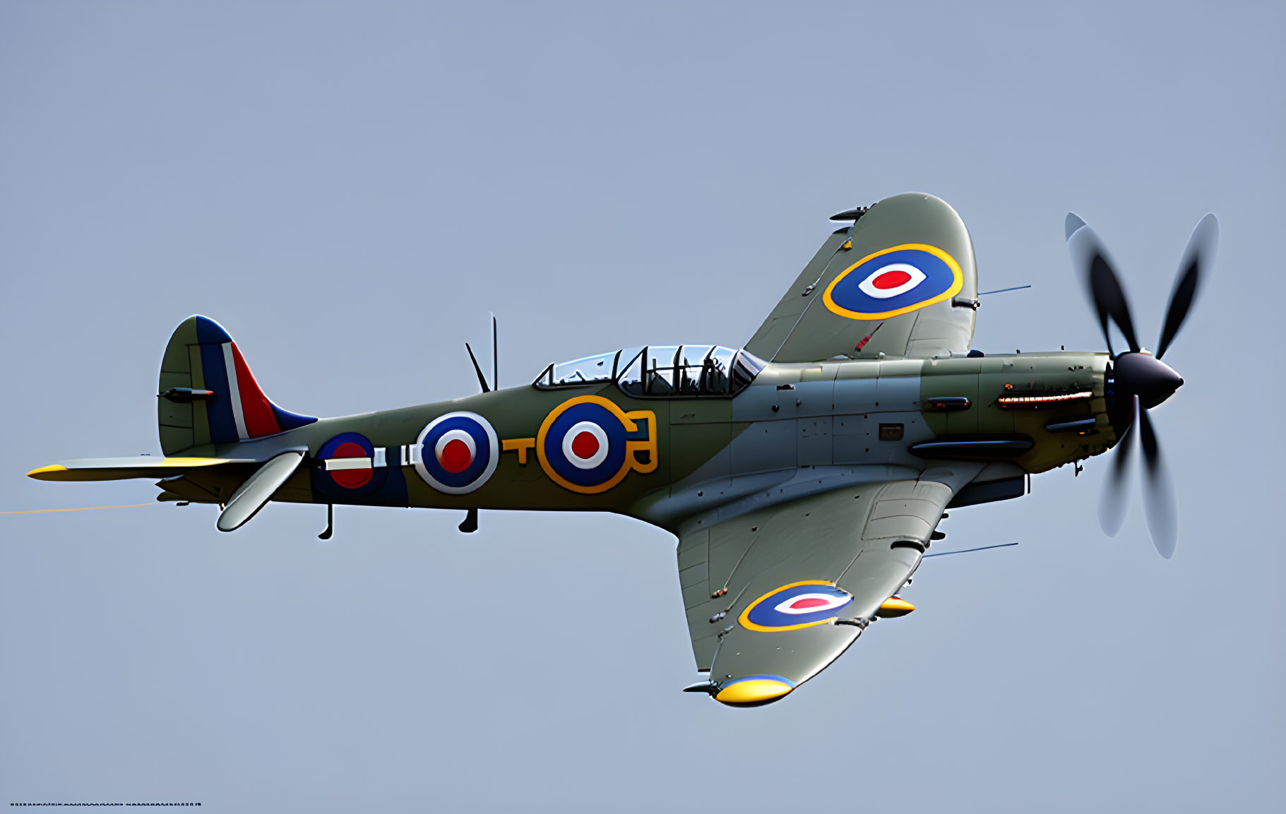 Vintage Military Aircraft with Camouflage Paint and Roundels Flying in Clear Blue Sky