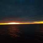 Tranquil Beach Sunset with Vibrant Orange Glow