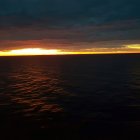 Luxurious Yacht Sailing on Calm Ocean at Sunset