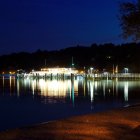 Illuminated cruise ship on calm lake at night