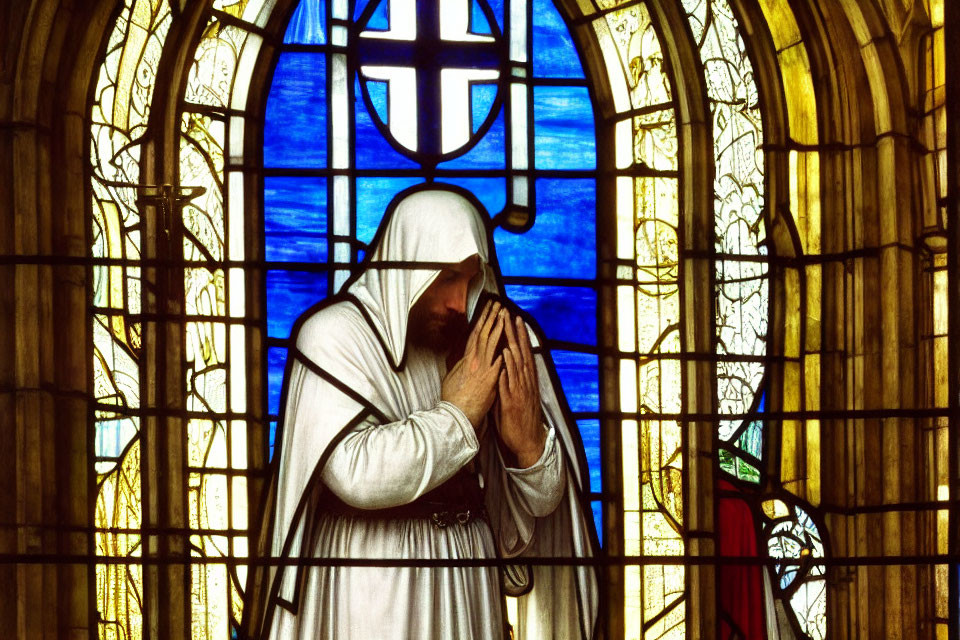 Colorful Stained Glass Window Featuring Figure in Prayer