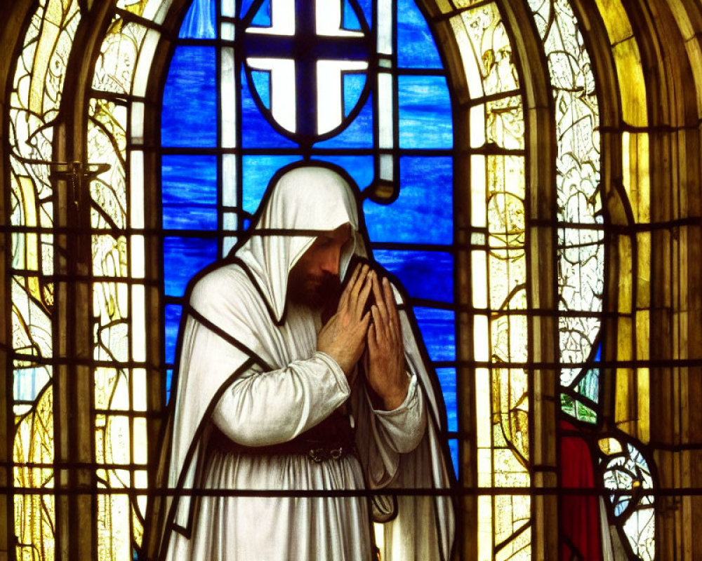 Colorful Stained Glass Window Featuring Figure in Prayer