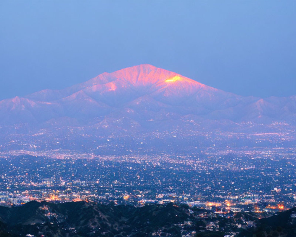 City Lights Against Mountain Twilight Sky