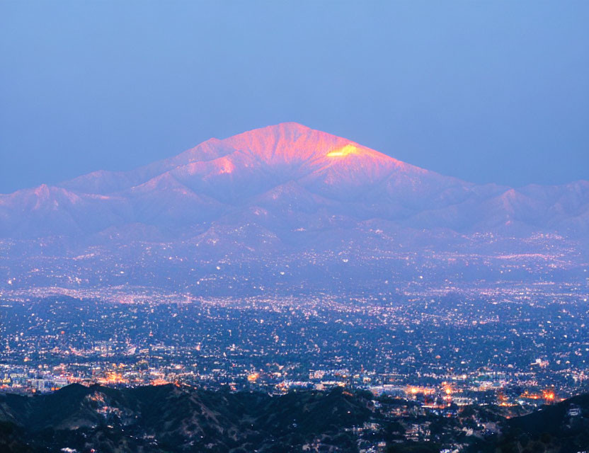 City Lights Against Mountain Twilight Sky