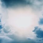 Dramatic fluffy cumulus clouds under sunlight on a soft blue sky