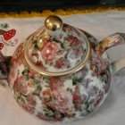 Porcelain Tea Set with Gold Trim and Floral Pattern on Display