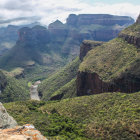 Lush Green Valley with Meandering River and Mountains