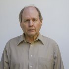 Realistic Bald Man Portrait in Grey Shirt on Pale Blue Background