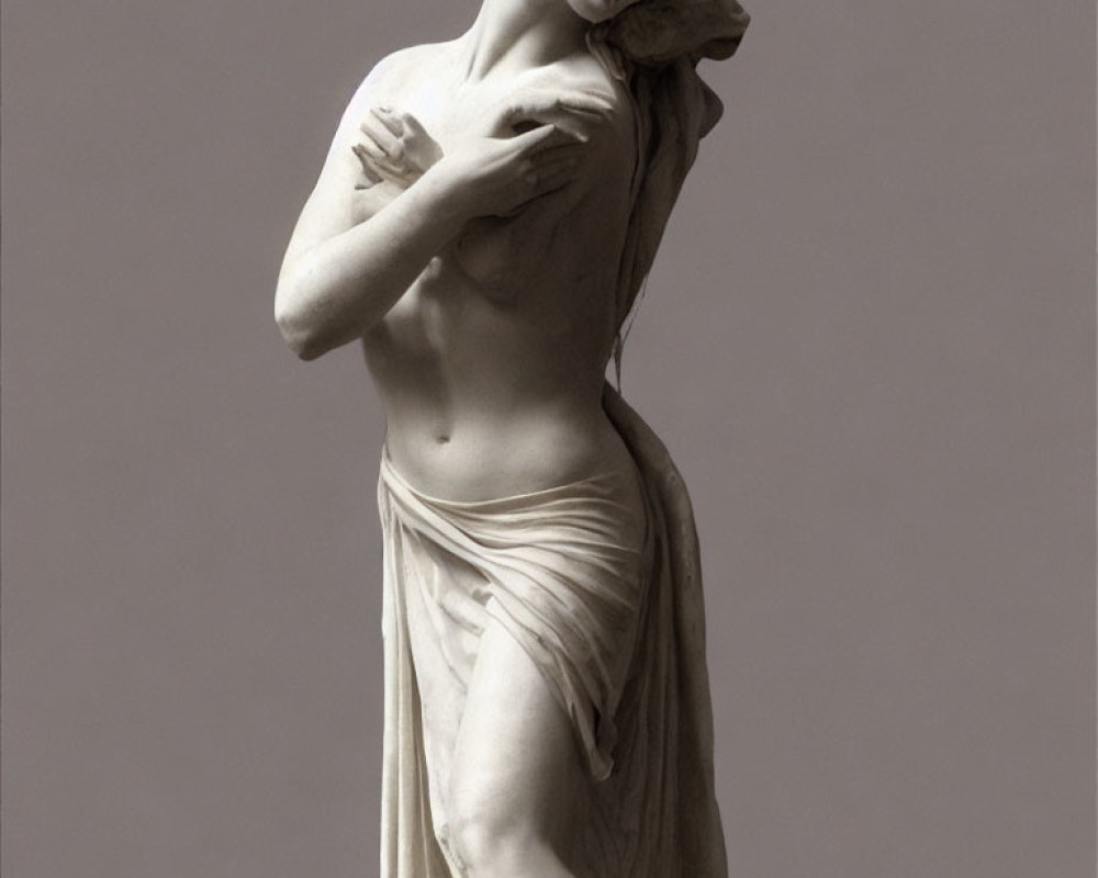 Marble statue of draped woman in reflective pose