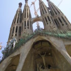 Intricate stone work and blue stained-glass windows of Sagrada Familia.