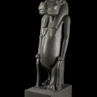 Stylized anthropomorphic cat with Egyptian design on pedestal