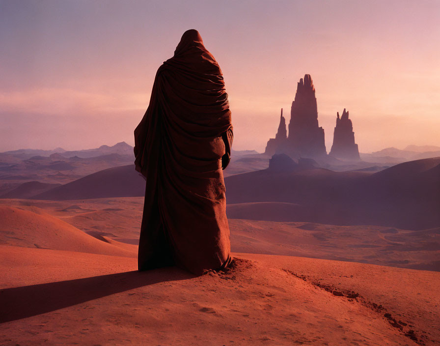 Robed Figure in Desert at Dusk with Sandstone Towers in Pink Sky