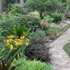 Scenic riverside garden with colorful flowers and small houses