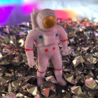 Astronaut in white spacesuit on colorful alien planet with nebula.