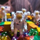 Colorful Gem-Like Structures Surround Astronaut Figurine