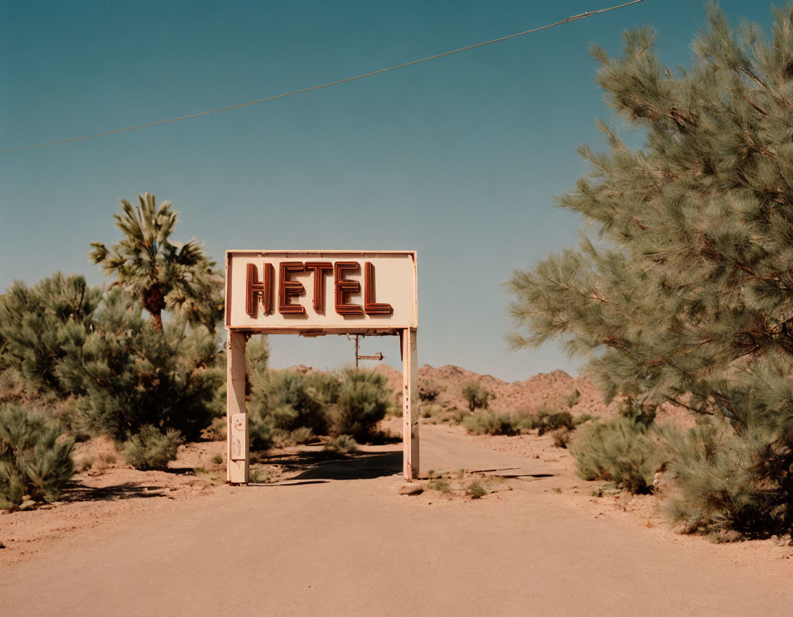 Deserted Road Hotel Sign in Arid Landscape