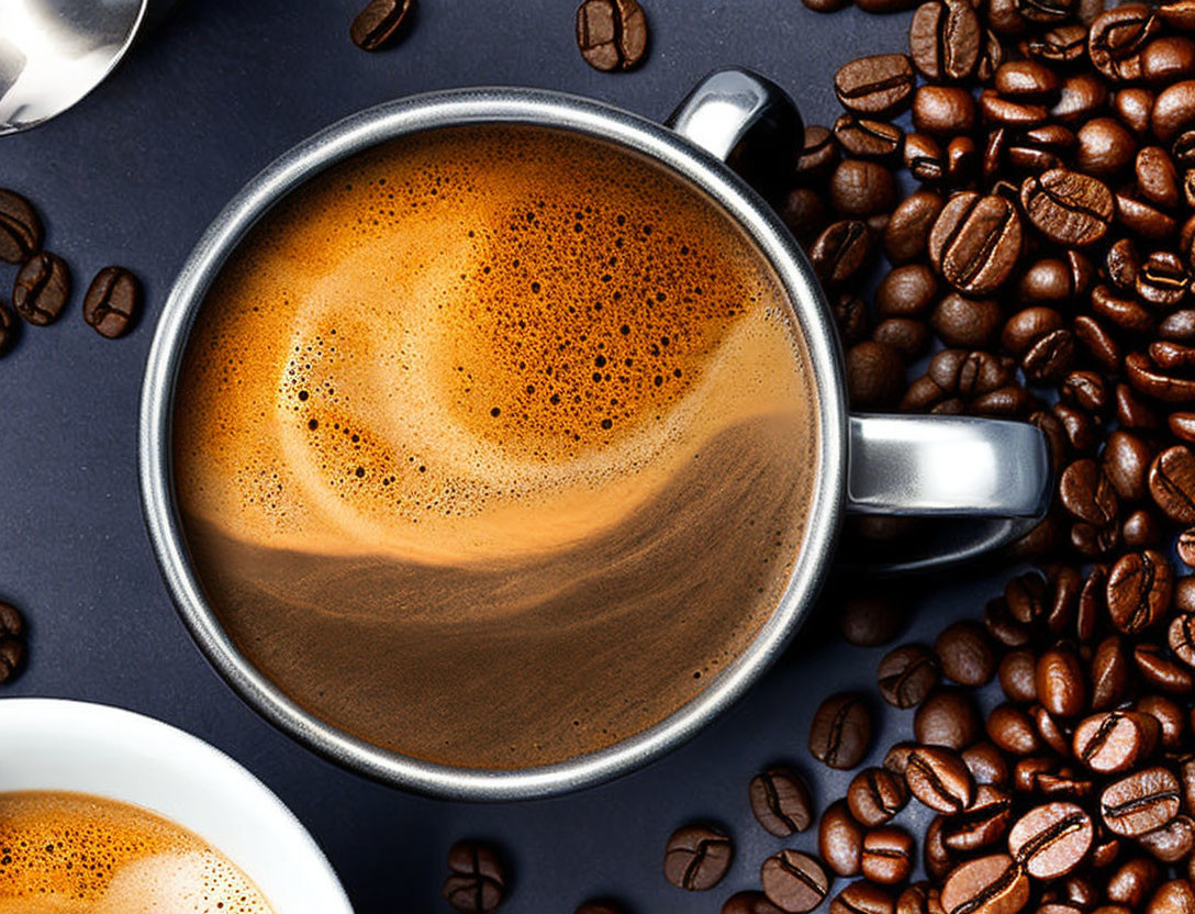 Frothy Espresso Cup with Coffee Beans on Dark Surface