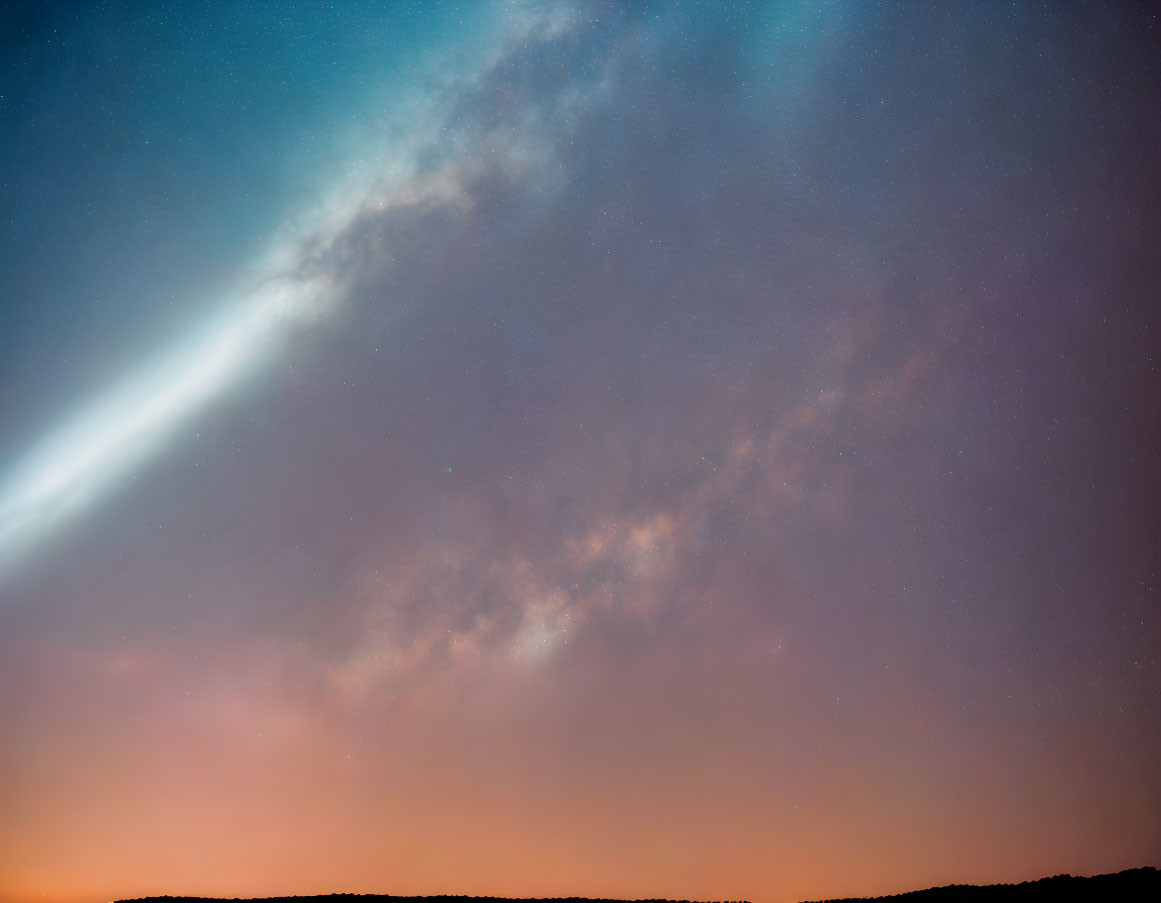 Twilight sky with blue and orange comet streaking amidst faint stars