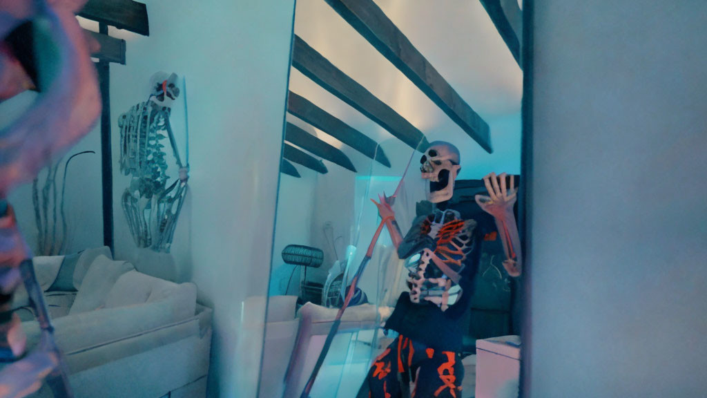 Skeleton costume person in modern room with blue lighting