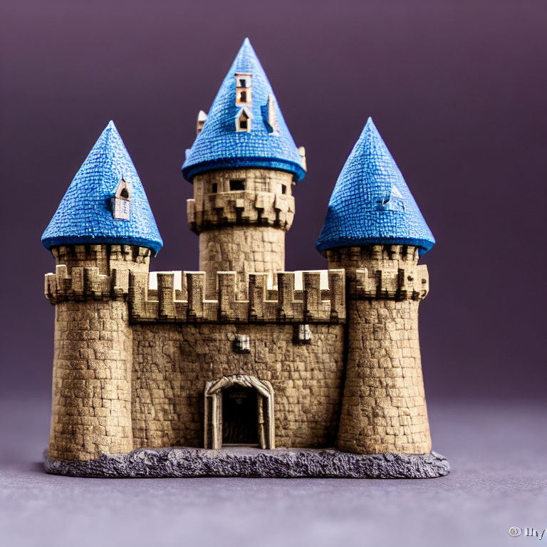 Miniature fairy-tale castle with blue roofs on purple background