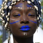 Vibrant polka dot woman with blue lips and silver earrings