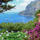 Vibrant coastal scene with flowers, boats, and cliffside buildings