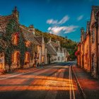 Twilight village scene with thatched-roof cottages and glowing lanterns