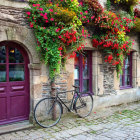 Cobblestone Street with Rustic Buildings, Flowers, and Vintage Bicycle