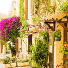 Traditional houses and vibrant bougainvillea on charming cobblestone street