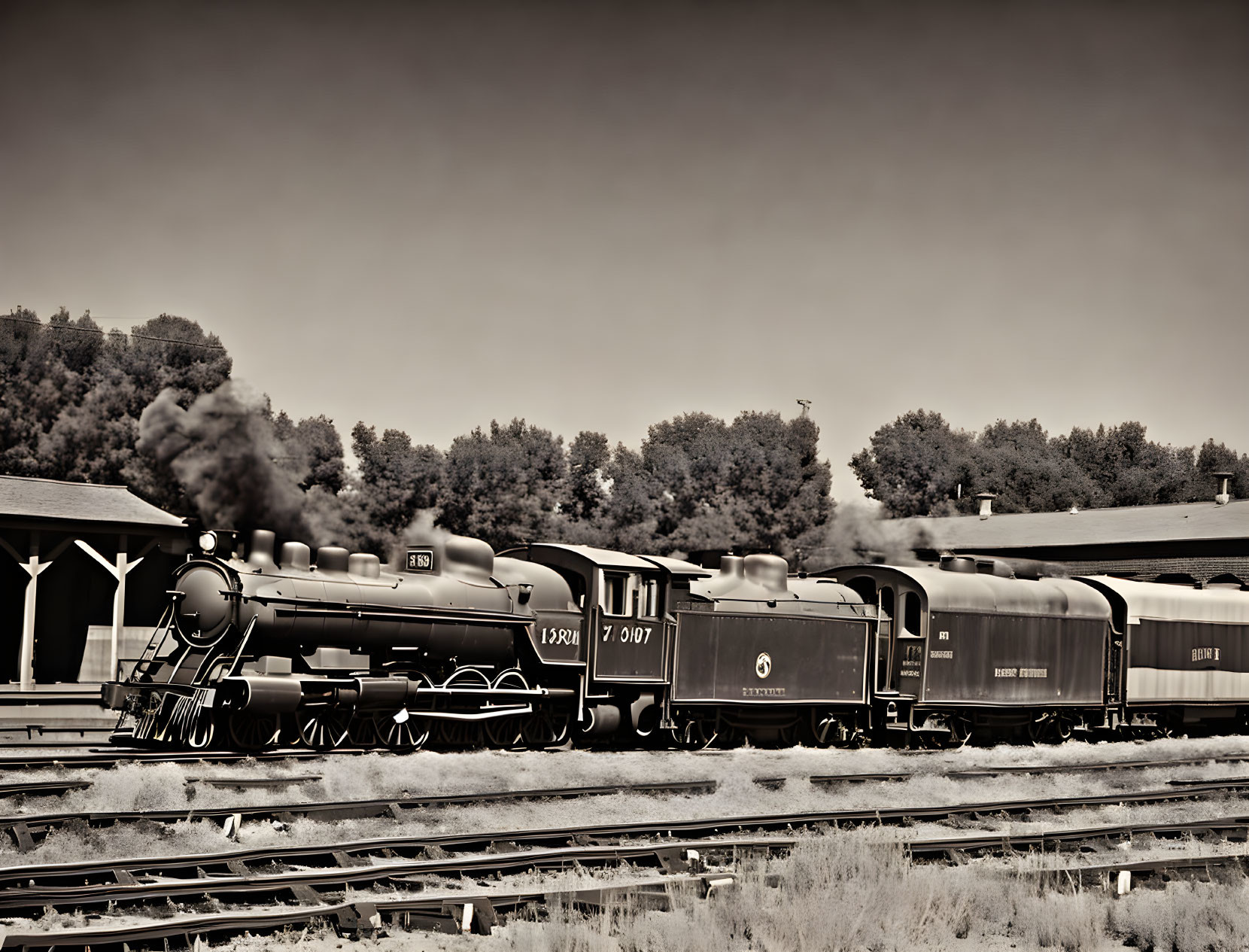 Vintage Black and White Photo: Steam Locomotive on Railway Tracks