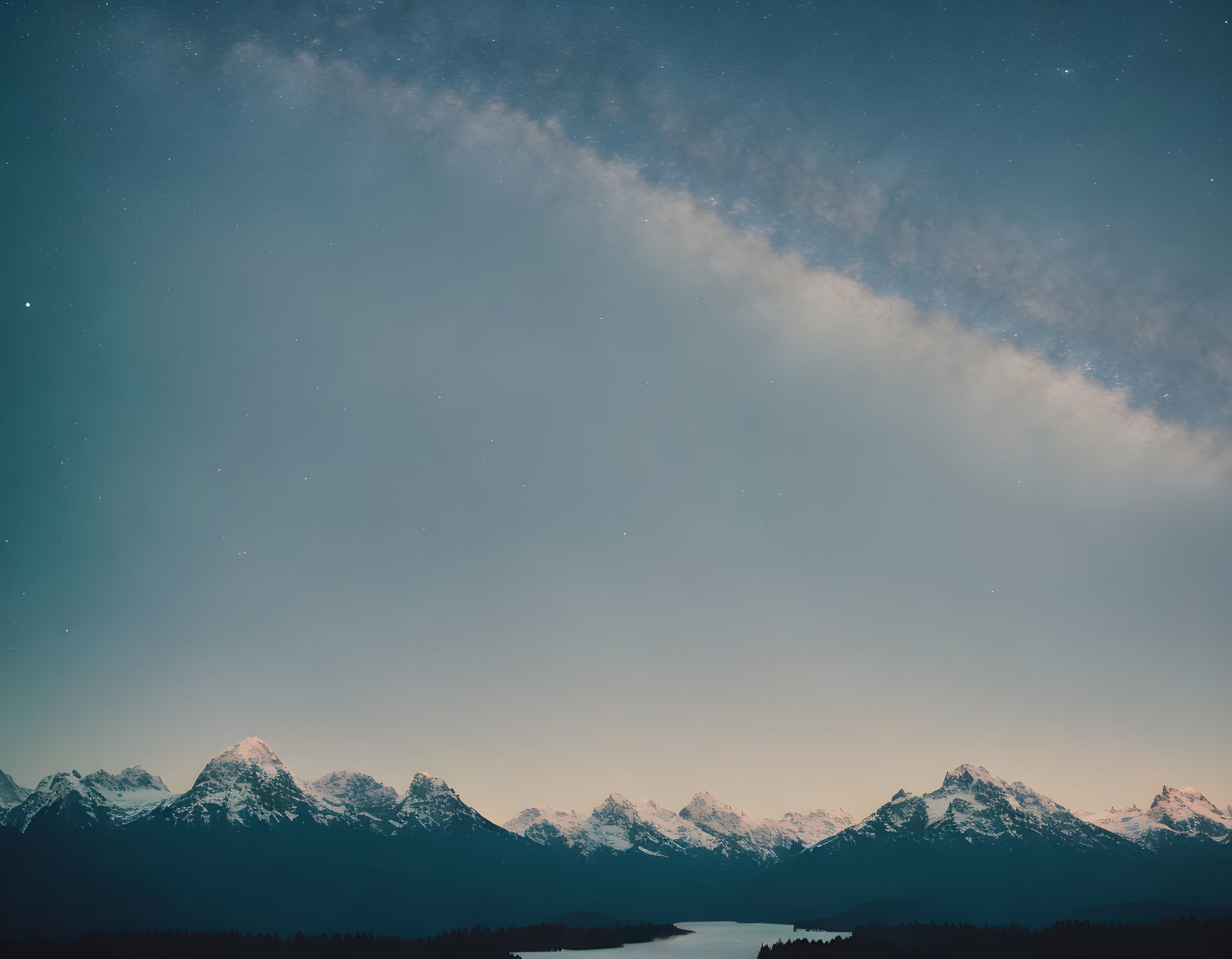 Mountain Peaks Silhouetted Against Starry Night Sky