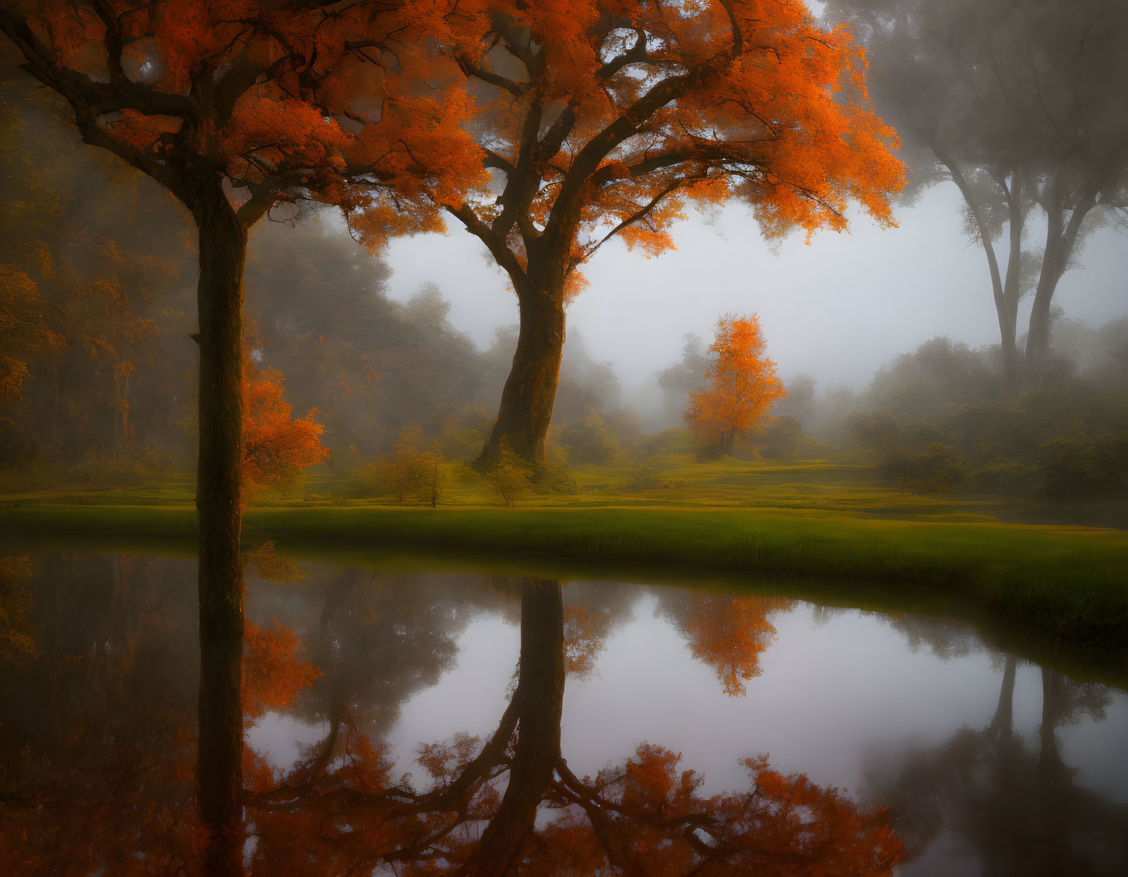 Tranquil autumn pond with orange-leaved trees