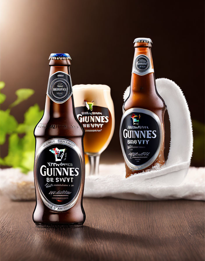 Guinness beer bottles and glass on wooden surface, frothy head overflowing.